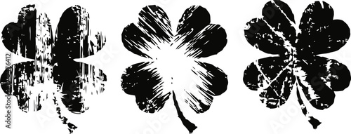 Grunge three leaf clover silhouettes with distressed textures against white background