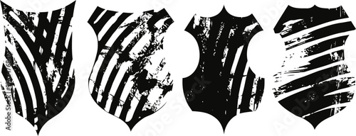 set of four black and white distressed shield emblems with unique abstract stripe patterns