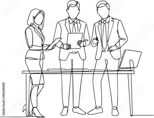 Diverse business professionals discussing documents at table, highlighting teamwork and corporate strategy in office setting