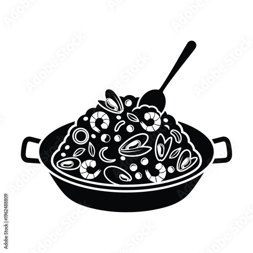 Delicious seafood paella in a pan with a spoon.