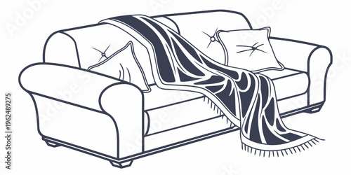 A cozy couch adorned with a striped blanket and decorative pillows.