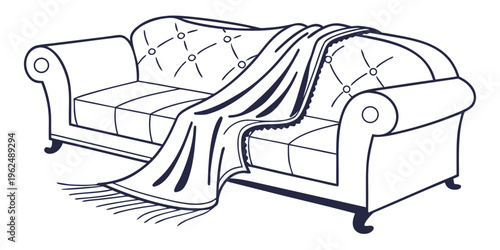 A cozy white couch with a blanket draped over the back and a pillow on the seat.