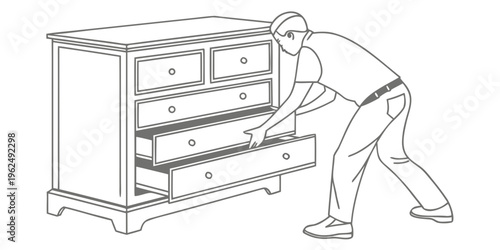 Man bending down to open the bottom drawer of a wooden dresser