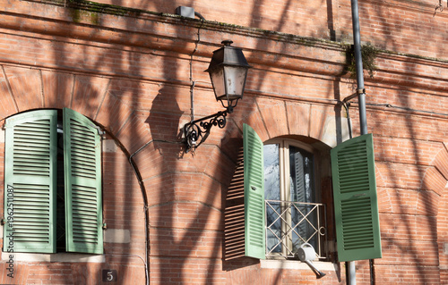 Old street lamp. Facade of an old building in Toulouse. France.