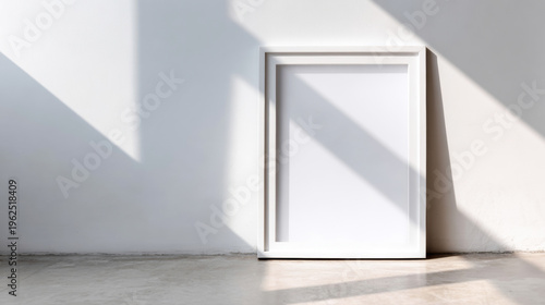 White empty picture frame leaning on wall, bright natural sunlight casting geometric shadows, modern minimal design
