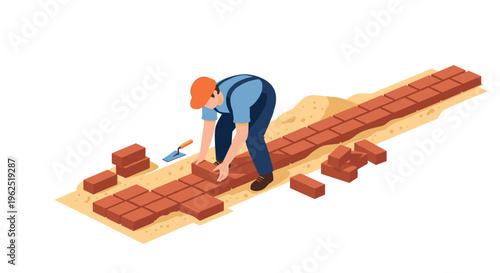 A construction worker in blue overalls lays red bricks on a sandy ground with a trowel nearby.