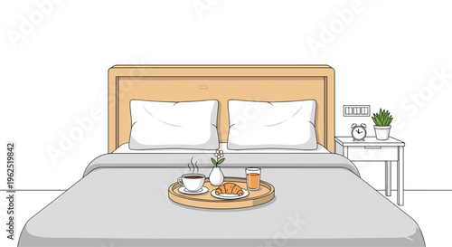 A breakfast tray with coffee, juice, and a croissant is placed on a grey-duvet bed with a wooden headboard and two white pillows.