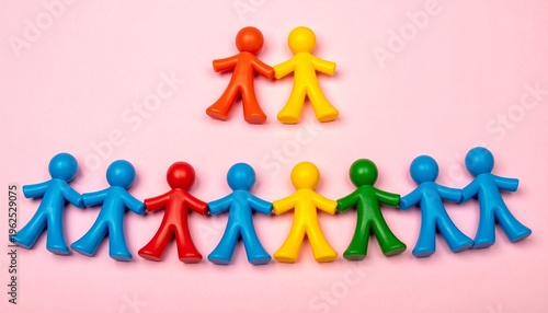 Colorful Miniature Figures in Rows on Pink Background