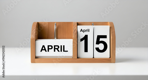 Wooden perpetual calendar showing April 15