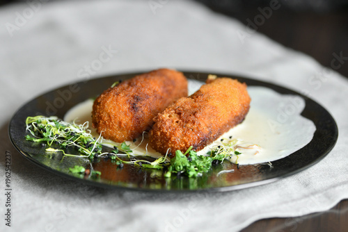 Crispy fish croquettes with creamy sauce gourmet french seafood dish