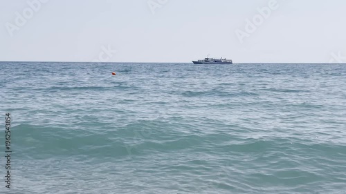 Boat travels on clear sea in daytime