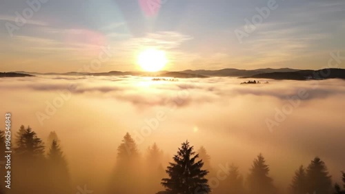 Sunrise over calm ocean horizon. Golden sun reflecting on water with lens flare. Panning timelapse footage.
