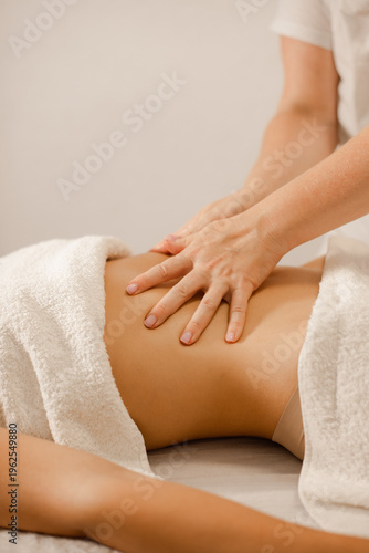 woman receiving abdominal massage therapy for relaxation and digestive wellness