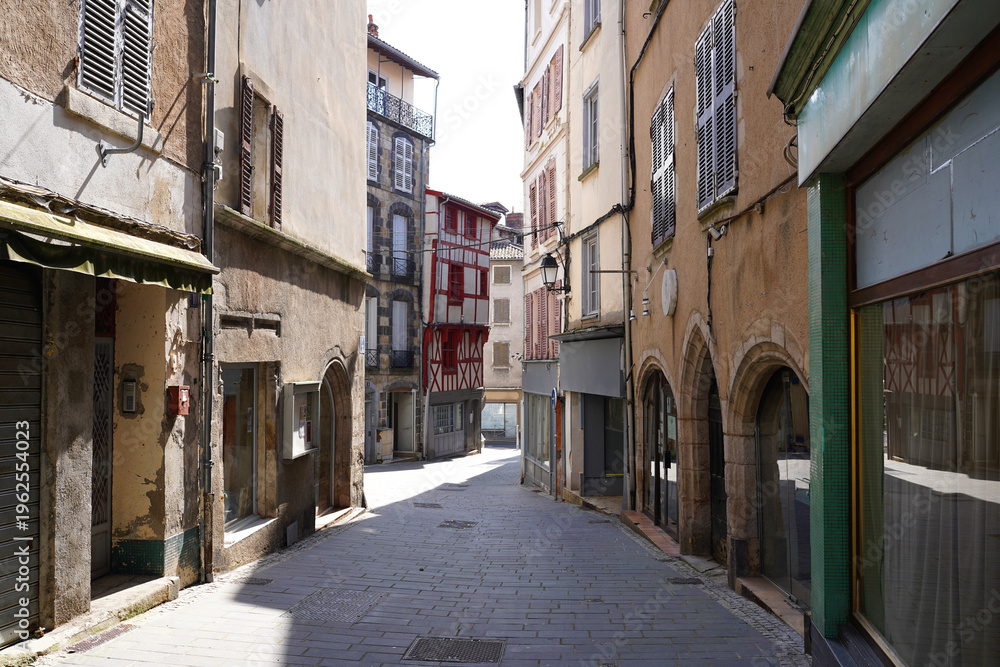 Obraz premium Medieval street in Thiers, France, with stone arches and half-timbered houses, Europe