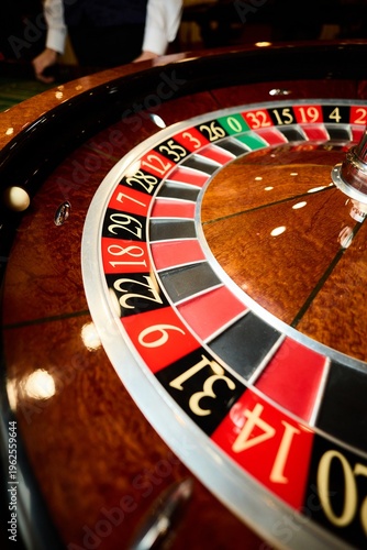 Fotografie Close up roulette wheel with ball in casino, gambling risk luck chance concept,