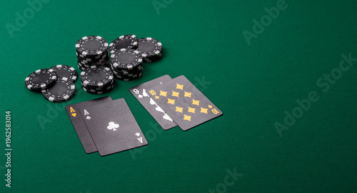 Playing cards and chips on a green cloth, a gambling game of blackjack or baccarat. Cards and chips