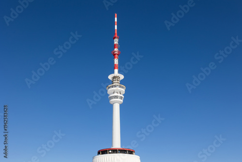 Television and communications tower and transmitter, Praded, Jeseniky mountains, Czech Republic, Czechia. Detail of tall utility building. Clear blue sky as copy space.