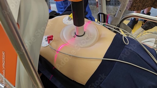 Person is being treated with a laser artificial heart massage on their back. The person is laying on a bed with a machine attached to their body