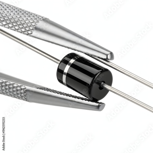 Black cylindrical electronic diode with silver bands and wire leads held by tweezers.