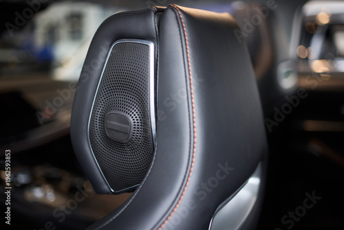 Bilde på lerret Closeup leather car headrest speaker with red contrast stitching, mesh grille, s