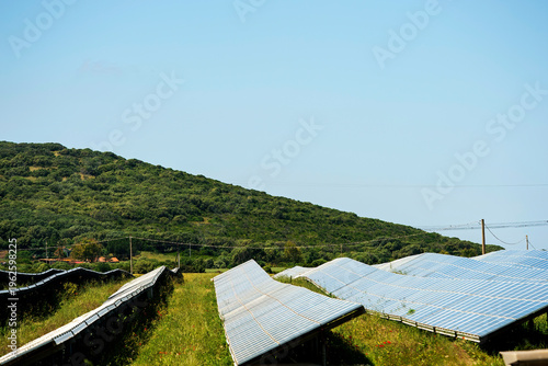 Картината върху платно a solar power station featuring numerous ground-mounted solar panels situated in a rural landscape
