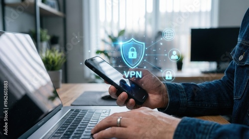 A person using VPN to secure data on phone and laptop