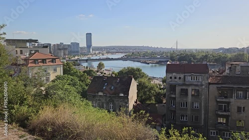 City view with a river in the background. The buildings are old and there are a few boats in the water in Belgrade