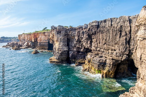 Boca do Inferno rock formations in Cascais, Portugal. Steep cliffs at Mouth of Hell limestone rock formations and sea caves in rugged shoreline of Atlantic ocean