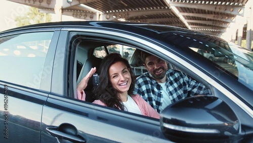 Canvas Print Happy woman showing car key. Buying a car. Slow motion