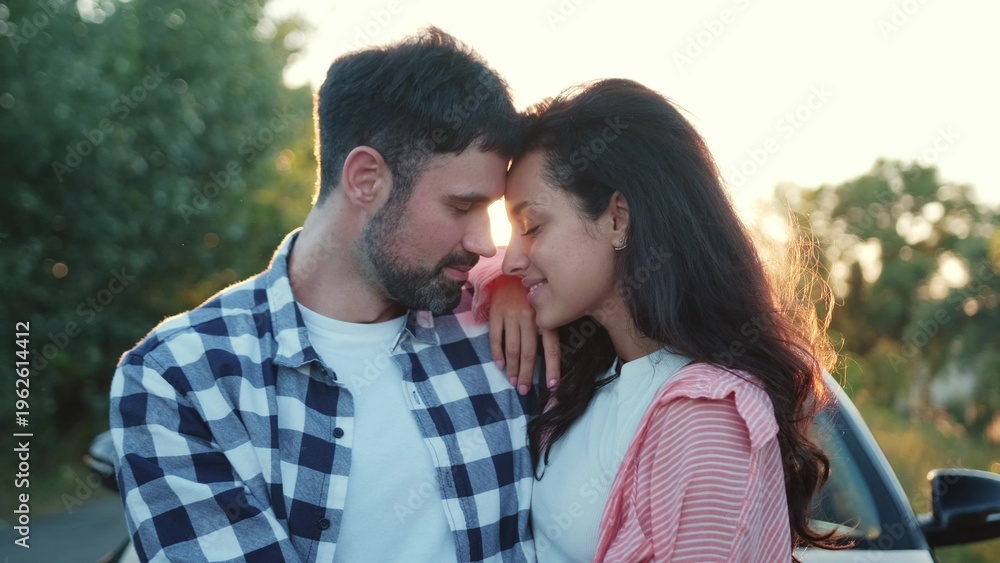 Obraz premium Happy couple during the romantic date on the sunset outdoors. Slow motion