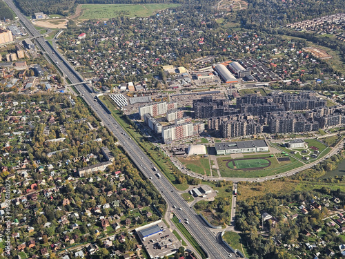 Wallpaper Mural City street with a large highway running through it. The street is lined with houses and buildings, and there are several cars on the road. Scene is busy and bustling, with a sense of movement Moscow Torontodigital.ca