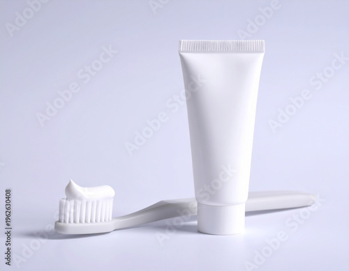 White Toothbrush and Blank Toothpaste Tube on Clean Background