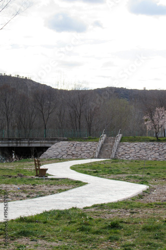 Curved pedestrian path leading to stairs in natural park landscape in Cuenca, Spain
