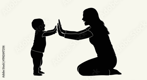 Silhouette of mother and child giving high five to each other
