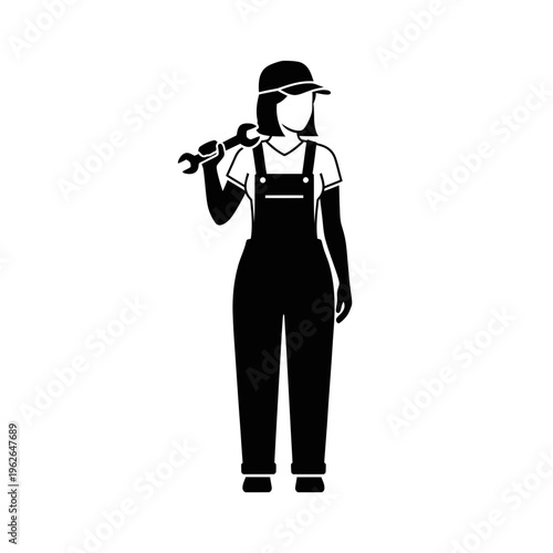 A woman wearing overalls and a hat holding a tool.