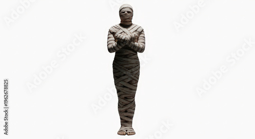 Ancient egyptian mummy wrapped in linen standing against white background with soft lighting