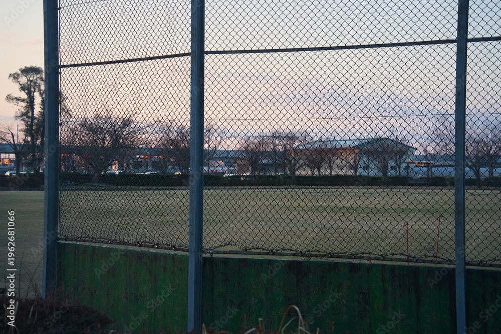 Fototapeta premium Sports field behind protective wire fence