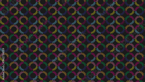 Illustration of multicolored ring and circle patterns on a black background.