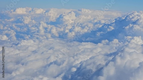 Wallpaper Mural The sky is filled with fluffy white clouds, creating a serene and peaceful atmosphere. The clouds are scattered throughout the sky, with some closer to the ground and others higher up Torontodigital.ca