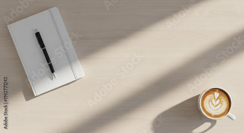 Coffee and notebook on wooden desk with sunlight
