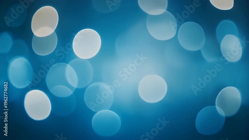 Abstract blue bokeh lights with a soft glow.