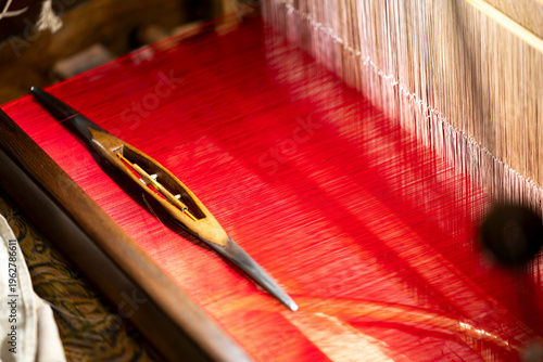 Fényképezés Traditional Sichuan Brocade Weaving Shuttle on Red Silk Loom at Chengdu Shu Broc