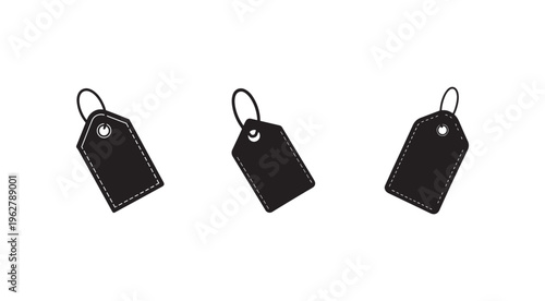 Three black price tags with white stitching and holes for strings  isolated on white background