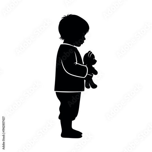 Silhouette of a young child holding a teddy bear.