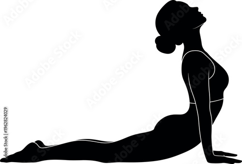 Silhouette of a woman in cobra pose a yoga stretch and exercise strengthening back muscles
