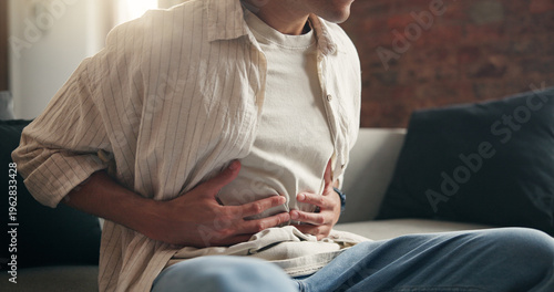 Tableau sur toile Man, hands and sick in home with stomach ache, indigestion and inflammation from diarrhea problem