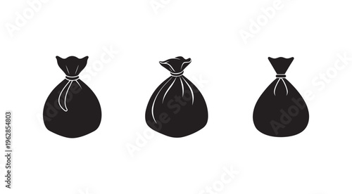 Three black trash bags with tied tops in different styles and sizes  isolated on white background