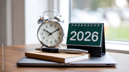 Professional workspace setup with 2026 calendar and alarm clock symbolizing future planning and deadlines on a