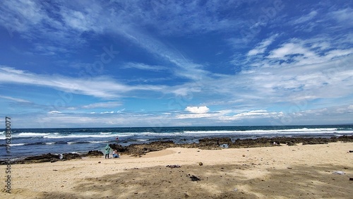 Wallpaper Mural Coastal view with rocky shore and ocean waves under a bright blue sky, showcasing natural seaside beauty. Torontodigital.ca