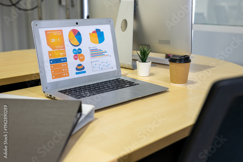 Business report and analytics on laptop computer workspace.Analysis financial data visualization tech for marketing strategy. 